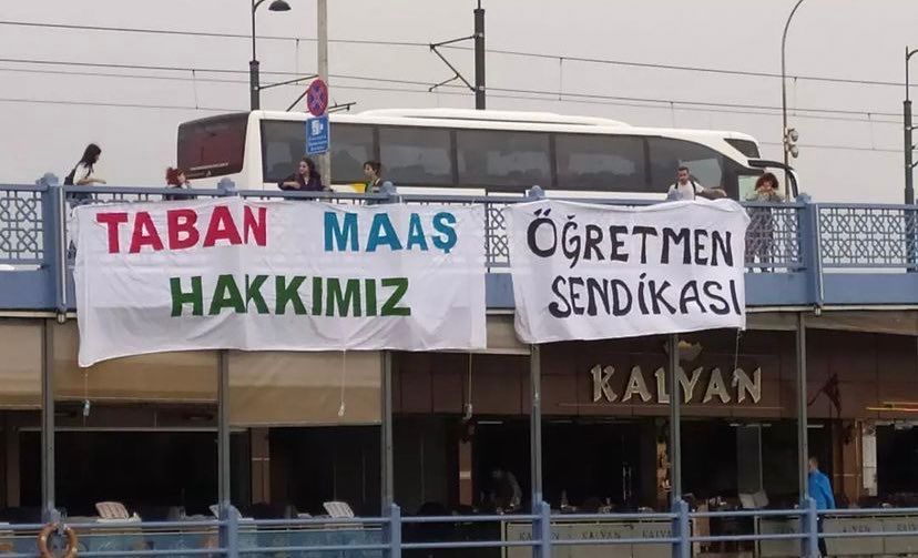 Teachers make a base salary call with the banners!